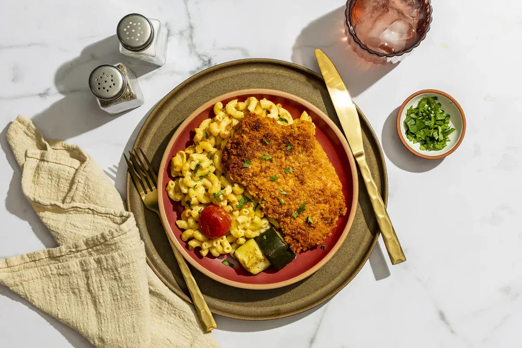 A chef-crafted meal featuring Chicken breast, wheat pasta, zucchini and cheddar jack cheese, prepared for a flavorful, balanced plate with clean ingredients and satisfying texture in every bite.