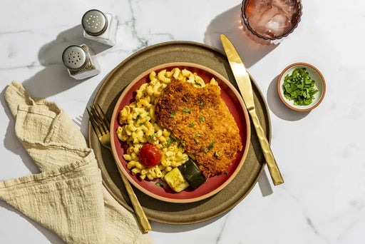 A chef-crafted meal featuring Chicken breast, wheat pasta, zucchini and cheddar jack cheese, prepared for a flavorful, balanced plate with clean ingredients and satisfying texture in every bite.