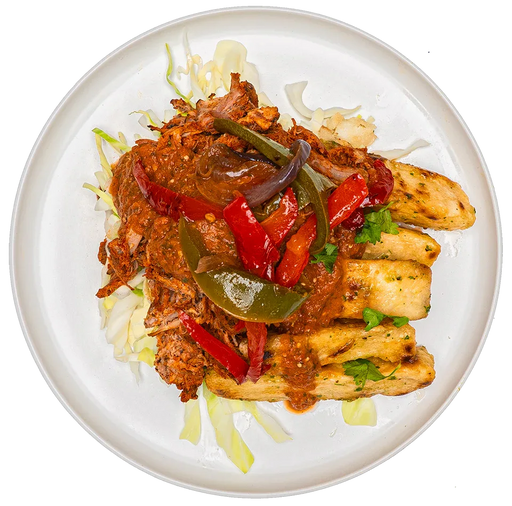 Plated dish with chicken, vegetables, and sauce on a white background