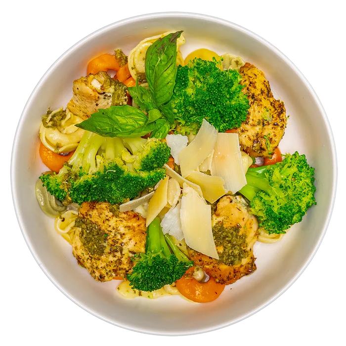 Plated dish with chicken, broccoli, carrots, and parmesan cheese on a white background