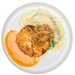 Plated dish with a meat patty, sauce, and garnishes on a white plate