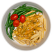 Pasta with cheese, green beans, and cherry tomatoes on a white plate