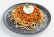 spartan meal preps miami - beef bolognese paired with pasta and cream on plate with cheese all over. Healthy meal from spartan meal preps miami.
