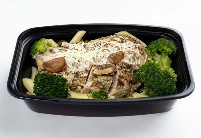 Prepared meal with chicken, broccoli, and pasta in a black tray.